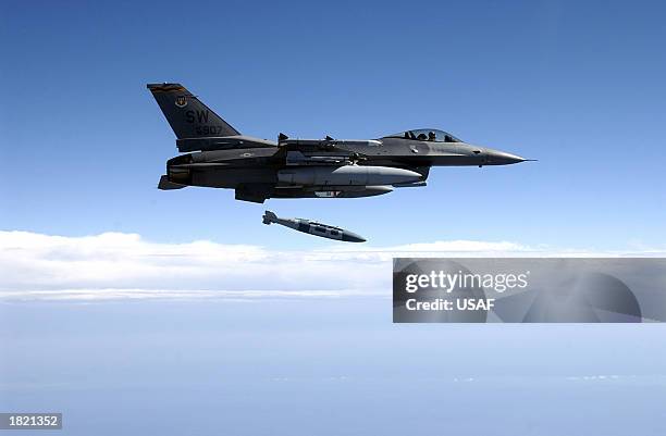 An F-16CJ from the 78th Fighter Squadron, at Shaw Air Force Base, South Carolina flies over the Eglin Land Range as the pilot releases a GBU-31 2,000...