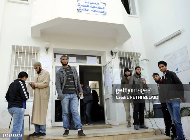 Salafist students stand guard in front of the office of the dean of the Faculty of Arts in Manuba, some 25 kms west of Tunis, on December 8, 2011....