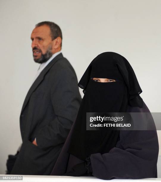 Student, wearing a niqab, stands on November 29, 2011 in the building housing the office of the dean of the Faculty of Arts at the University of...