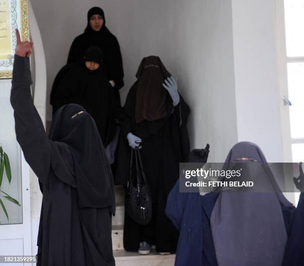 Group of students, wearing niqabs, try on November 29, 2011 to enter the building housing the office of the dean of the Faculty of Arts at the...