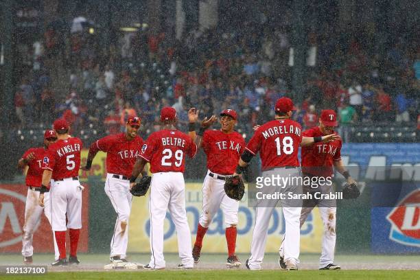 Mitch Moreland of the Texas Rangers celebrates with Adrian Beltre and Ian Kinsler after a game against the Los Angeles Angels of Anaheim at Rangers...