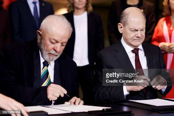 German Chancellor Olaf Scholz and Brazilian President Luiz Inacio Lula da Silva sign a bilateral contract as other members of the German govenment...