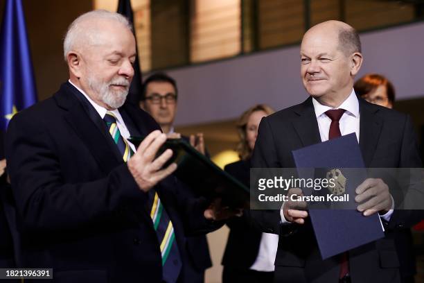 German Chancellor Olaf Scholz and Brazilian President Luiz Inacio Lula da Silva hold a bilateral contract as other members of the German govenment...