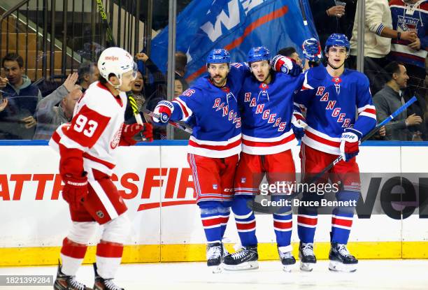 Artemi Panarin of the New York Rangers celebrates his second period goal against the Detroit Red Wings and is joined by Vincent Trocheck and Braden...