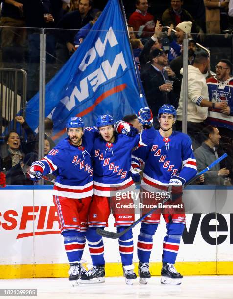 Artemi Panarin of the New York Rangers celebrates his second period goal against the Detroit Red Wings and is joined by Vincent Trocheck and Braden...
