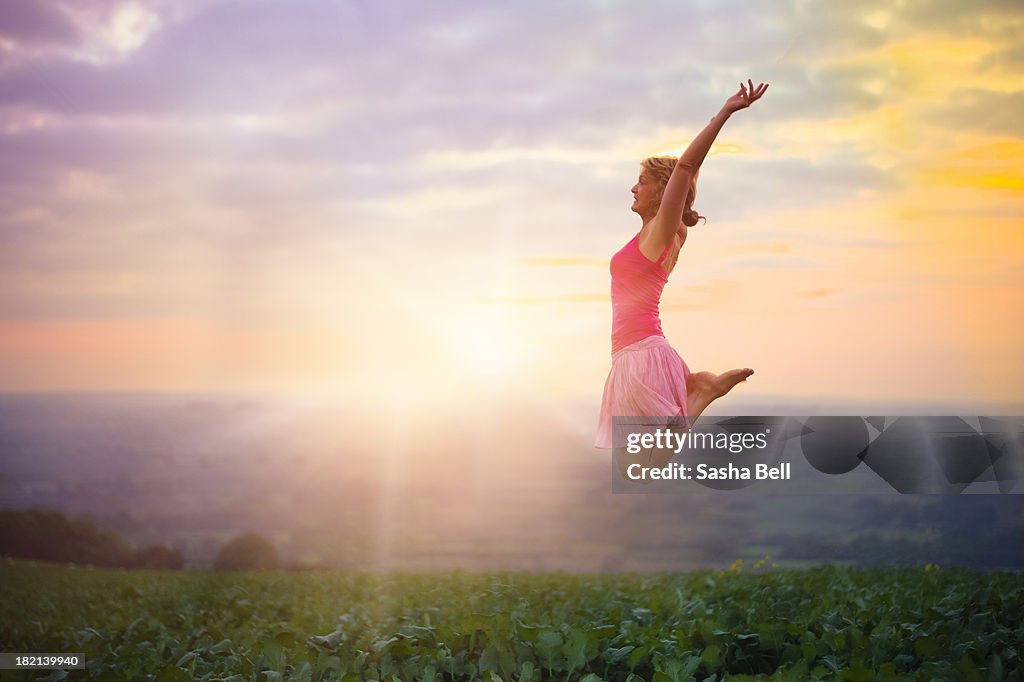 Woman Jumping at Sunset