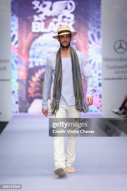 Model walks the runway at the Black Spring/Summer 2014 collection during the third day of Mercedes-Benz Fashion Week Mexico at Campo Marte on...