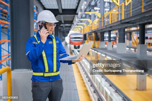 engineer talking or discussion with smartphone in railway workshop for engineering industry or transportation concept. - train driver stock pictures, royalty-free photos & images