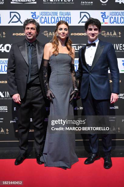 Italian former football player and and vice-president of the Italian Football Federation Demetrio Albertini poses with his wife Uriana and their son...