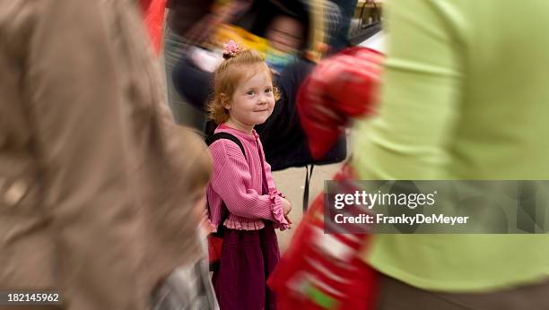 girl lost in crowd on first day at school - busy toddlers stock pictures, royalty-free photos & images