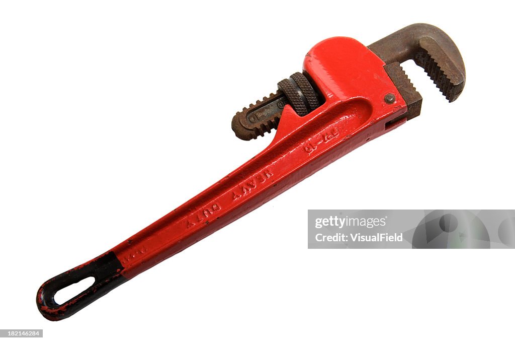 Red adjustable pipe wrench laying on a white background