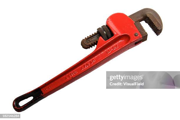 red adjustable pipe wrench laying on a white background - adjustable wrench stock pictures, royalty-free photos & images