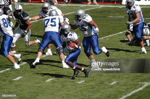 young football player rushing for a touchdown - football player tackle stock pictures, royalty-free photos & images