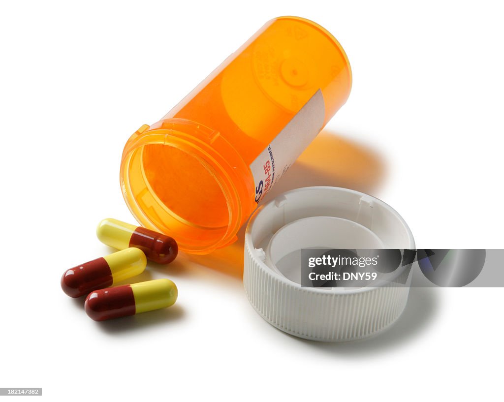 Open bottle of prescription drugs isolated on white background