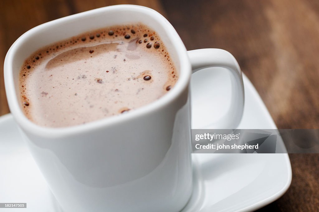 Close up of square cup filled with hot chocolate drink