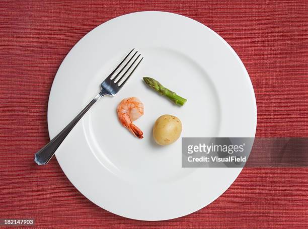absurdly small diet meal - portion control stock pictures, royalty-free photos & images