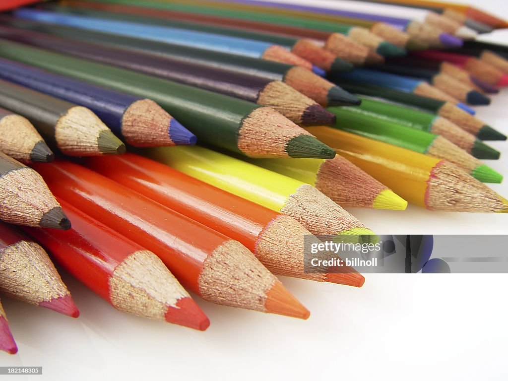 Colored art pencils close up against white