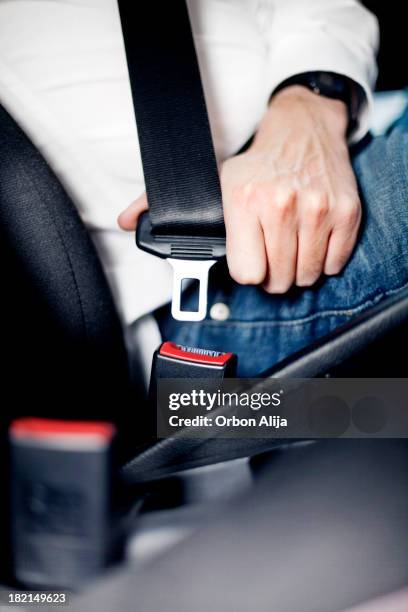 man fastening seat belt - seat belt stock pictures, royalty-free photos & images