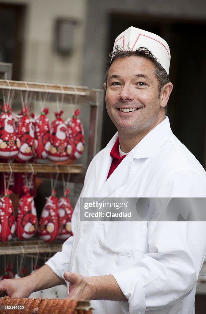 Butcher with fresh sausages