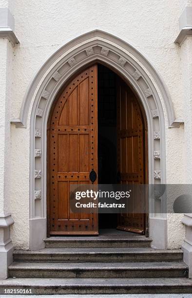 wooden door half open on a medieval style building entrance - half open stock pictures, royalty-free photos & images