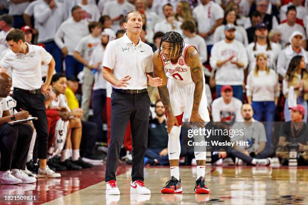 Head Coach Eric Musselman talks on the floor with Khalif Battle of the Arkansas Razorbacks during the first half of the game against the Duke Blue...