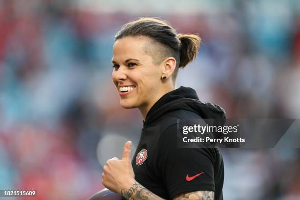 San Francisco 49ers offensive assistant coach Katie Sowers walks on the field against the Kansas City Chiefs prior to Super Bowl LIV at Hard Rock...