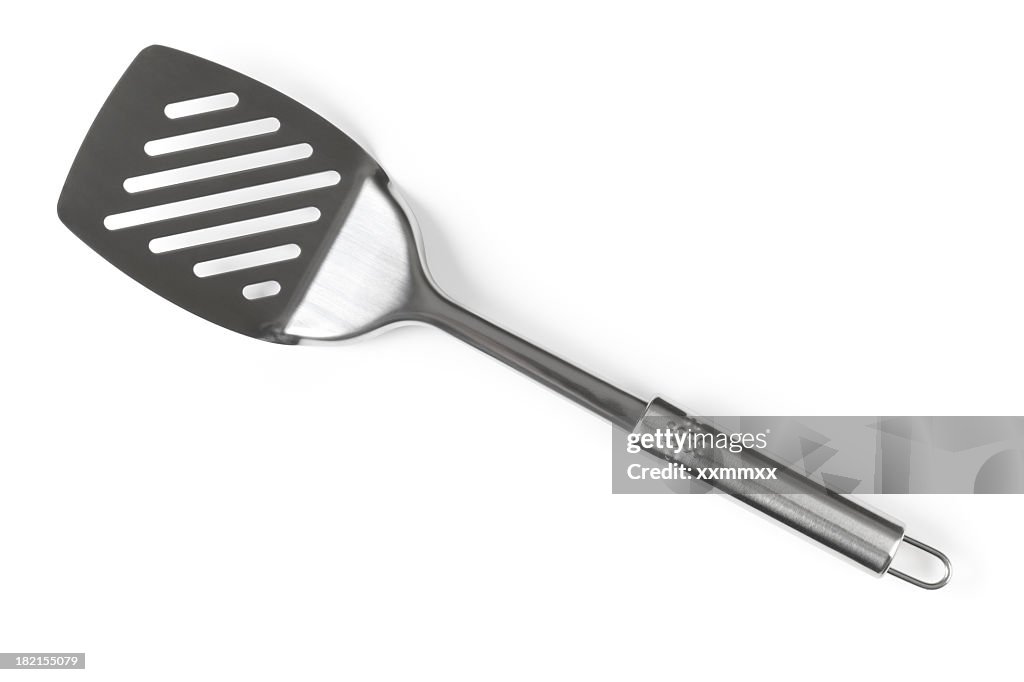 A silver spatula angled diagonally 