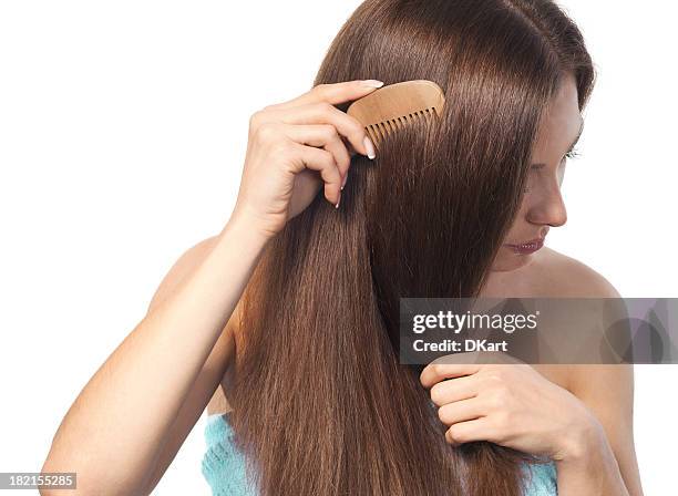 young brunette lady combing her long hair with a wooden comb - combing bildbanksfoton och bilder