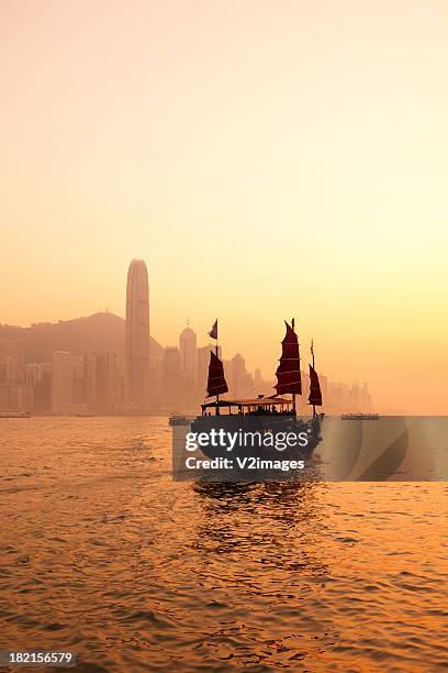 sunset in hong kong - junk ship stock pictures, royalty-free photos & images