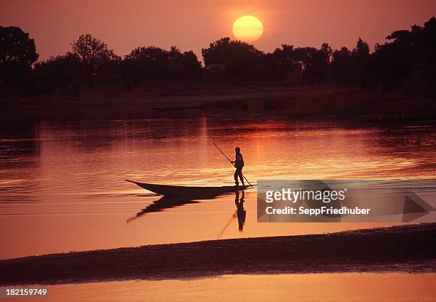 boat on the bani river in mali during sunrise - mali stock pictures, royalty-free photos & images