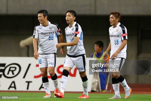 Yu Kobayashi of Kawasaki Frontale celebrates with teammates Yusuke Tasaka and Yoshito Okubo after scoring his team's first goal during the J.League...