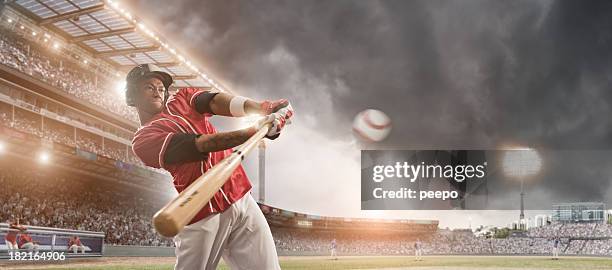 baseball player hitting ball - baseball player swinging stock pictures, royalty-free photos & images