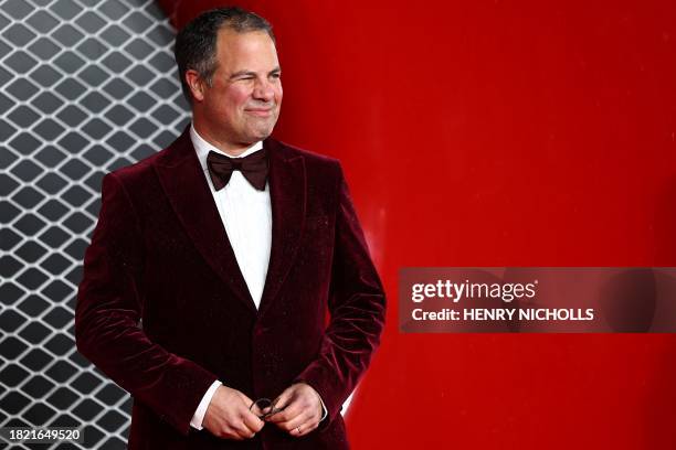 British journalist Ted Kravitz poses on the red carpet upon arrival for the UK premier of "Ferrari" at the Odeon Luxe Leicester, in central London,...