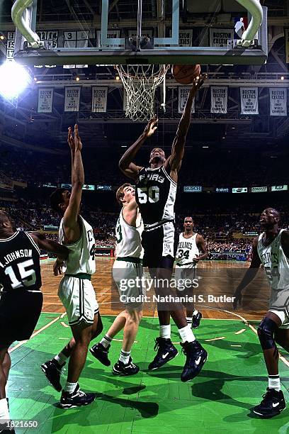 David Robinson of the San Antonio Spurs drives to the basket for a layup against the Boston Celtics at the Boston Garden during the 1991 season in...
