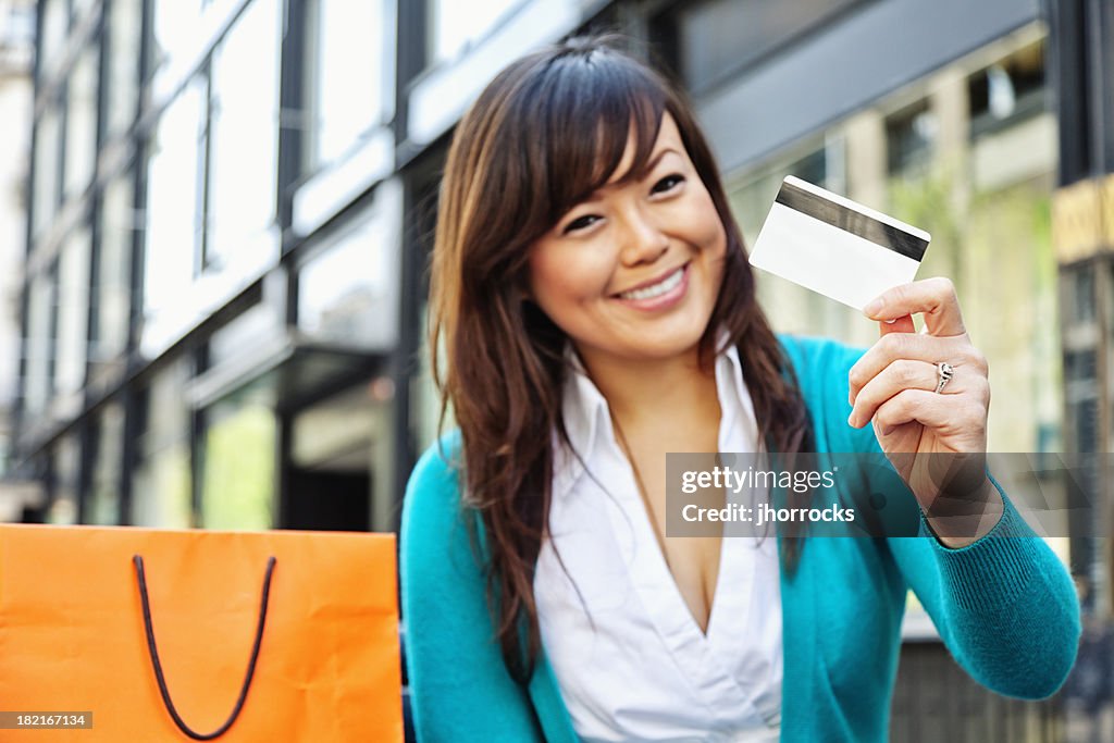 Enthusiastic Young Asian Woman with Credit Card