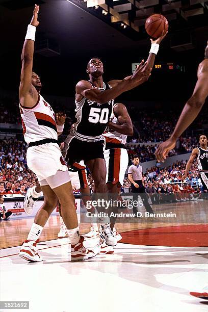David Robinson of the San Antonio Spurs drives to the basket for a layup against the Portland Trail Blazers at the Memorial Coliseum during the 1989...