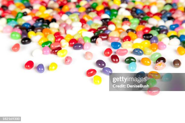 jelly beans scattered on a white background - jellybean stock pictures, royalty-free photos & images