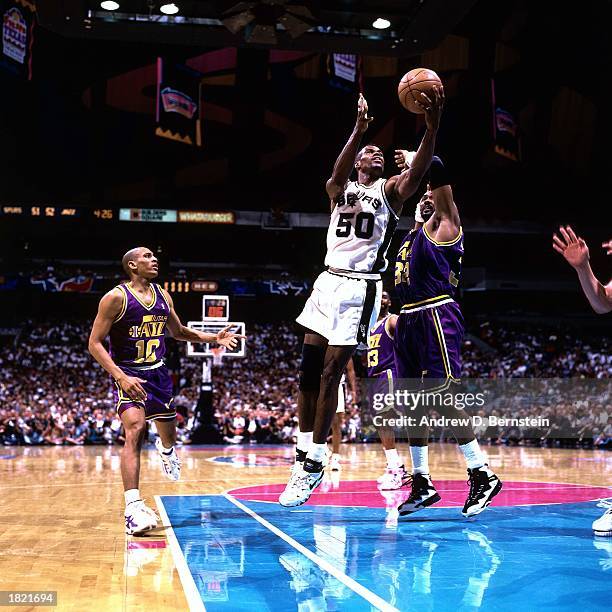 David Robinson of the San Antonio Spurs drives to the basket for a layup against Karl Malone of the Utah Jazz during Game Two of the Western...
