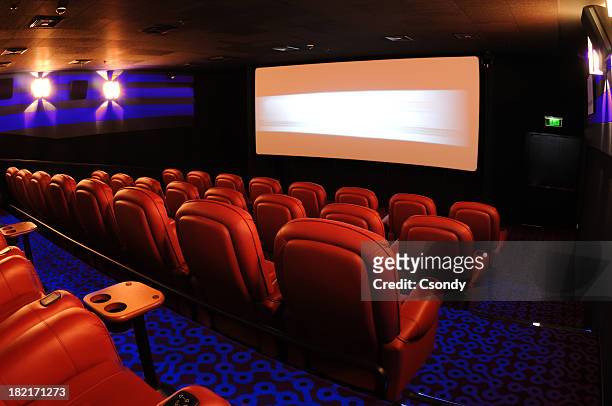 rows of red movie theater seats facing the movie screen - film in california conference stock pictures, royalty-free photos & images