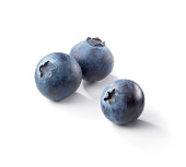 Three blueberries on a white background