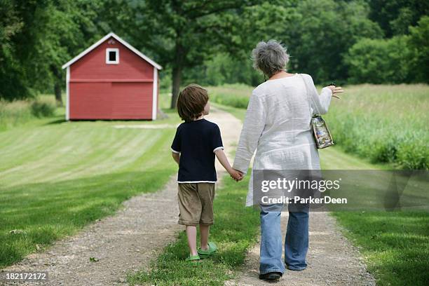 grandmother and grandson taking  walk on beautiful trail- red barn - beautiful granny bildbanksfoton och bilder