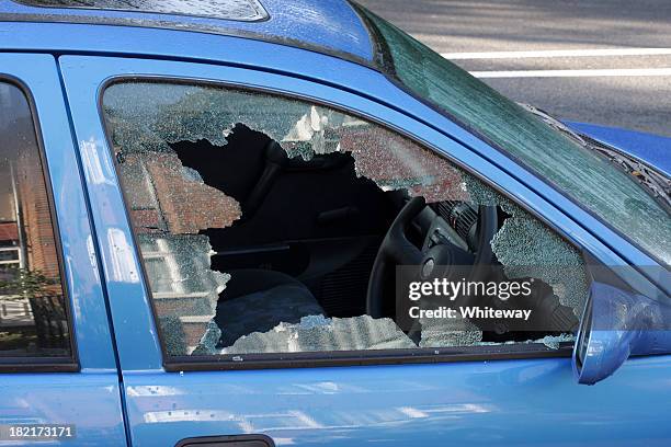 window smashed by car thief street scene - up on a roof stockfoto's en -beelden