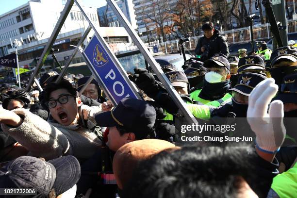 Dogs farmers scuffle with police officers during a protest, demanding the government scrap plans to pass a bill to enforce a ban on the consumption...