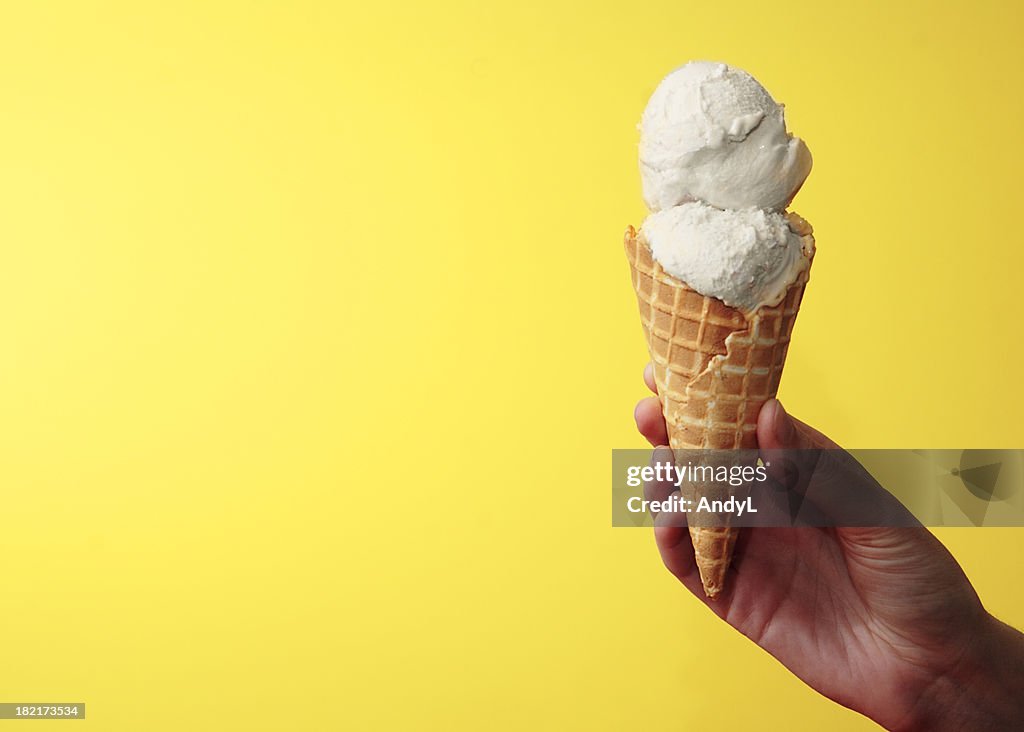 Cono gelato alla vaniglia su giallo con spazio per il testo