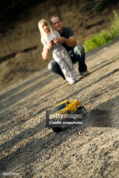 child girl and father playing with remote car summer lifestyle - remote controlled car stockfoto's en -beelden