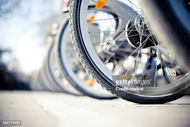 bikes for rent - bicycle parking station stock pictures, royalty-free photos & images
