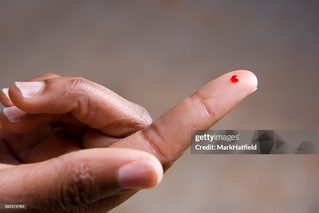 Drop of blood on fingertip for a medical exam