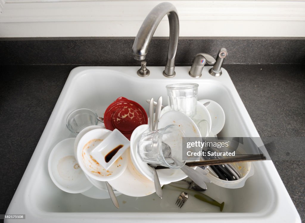 Pile of Dirty Dishes in A Sink
