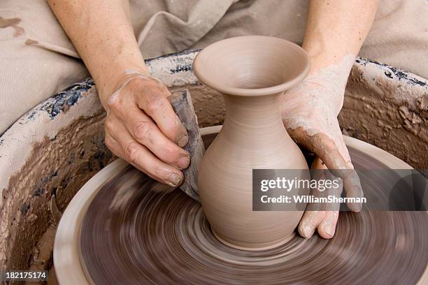 potter with smoothing tool - potter's wheel stock pictures, royalty-free photos & images