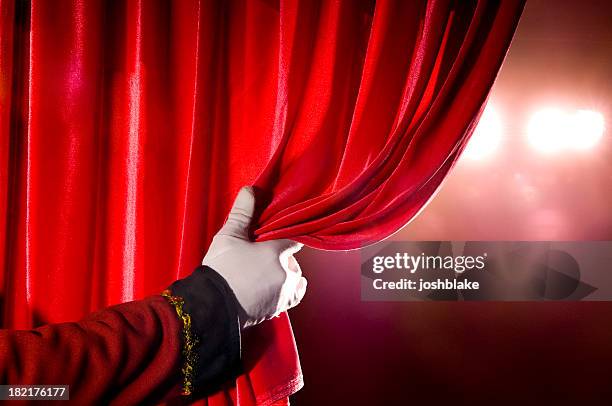 usher opening red theater curtain, with spotlights - the theater stock pictures, royalty-free photos & images